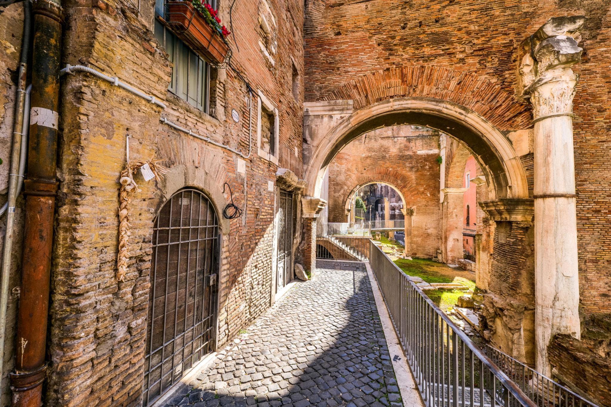 The Portico d'Ottavia archway in Rome's Jewish Quarter, with the medieval church of Sant'Angelo in Pescheria built directly into the ancient ruins