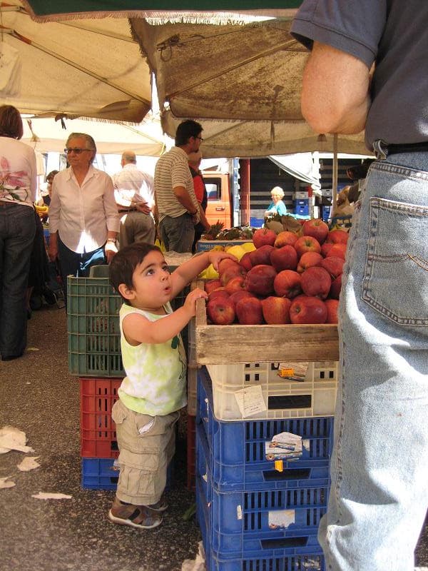 Child grabbing an apple at Testaccio Market