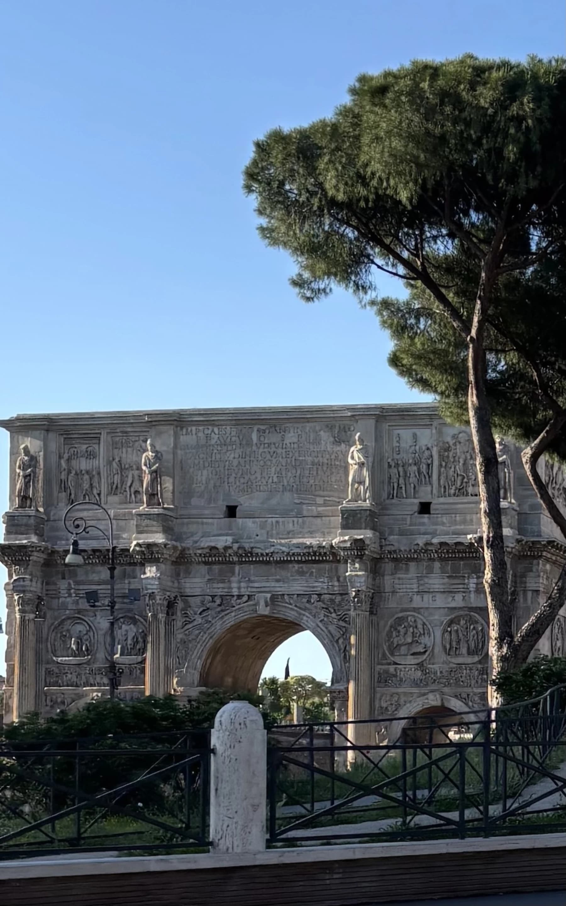 The Arch of Constantine against a clear blue sky