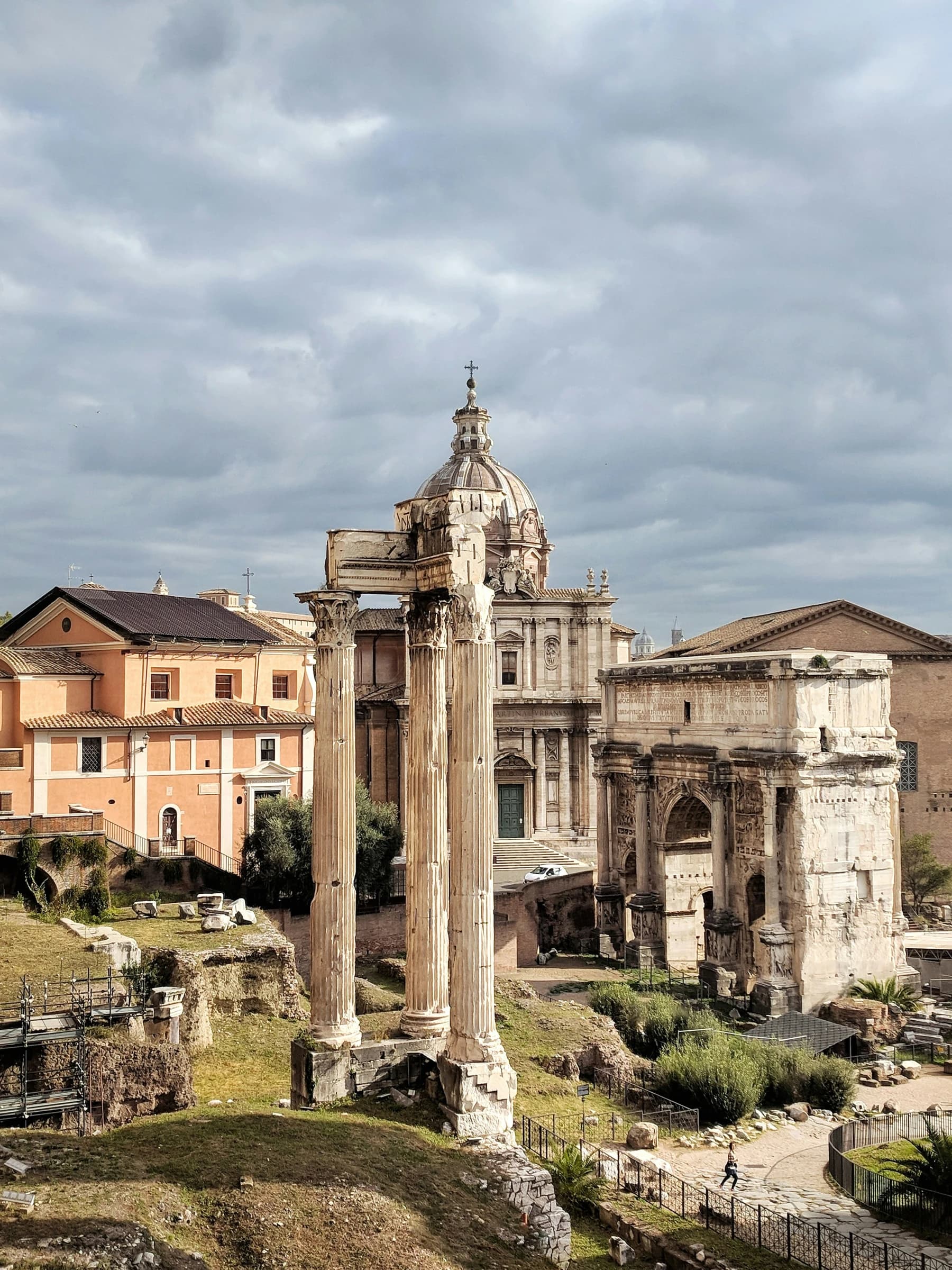 Heavy cloud cover over the Roman Forum's columns and the Arch of Septimius Severus