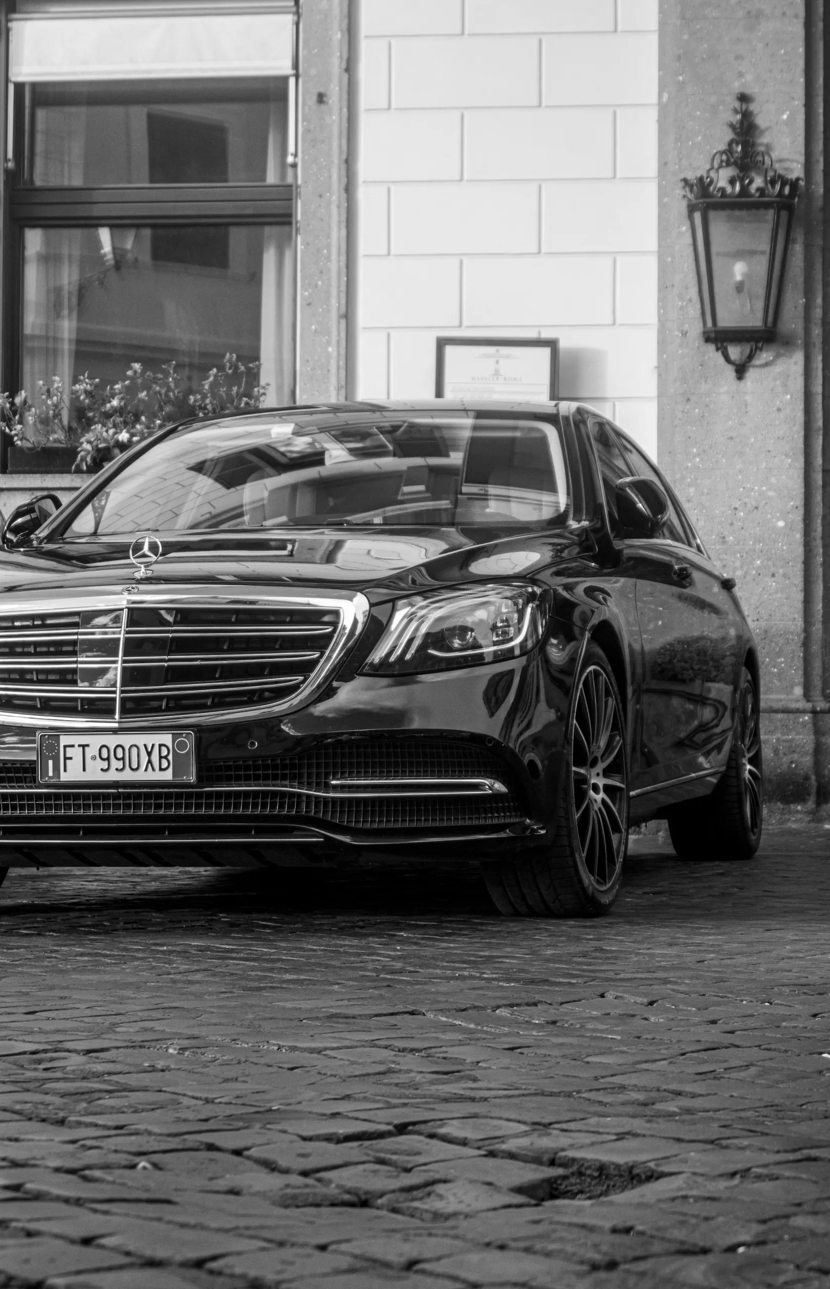 Mercedes sedan on cobblestones in central Rome