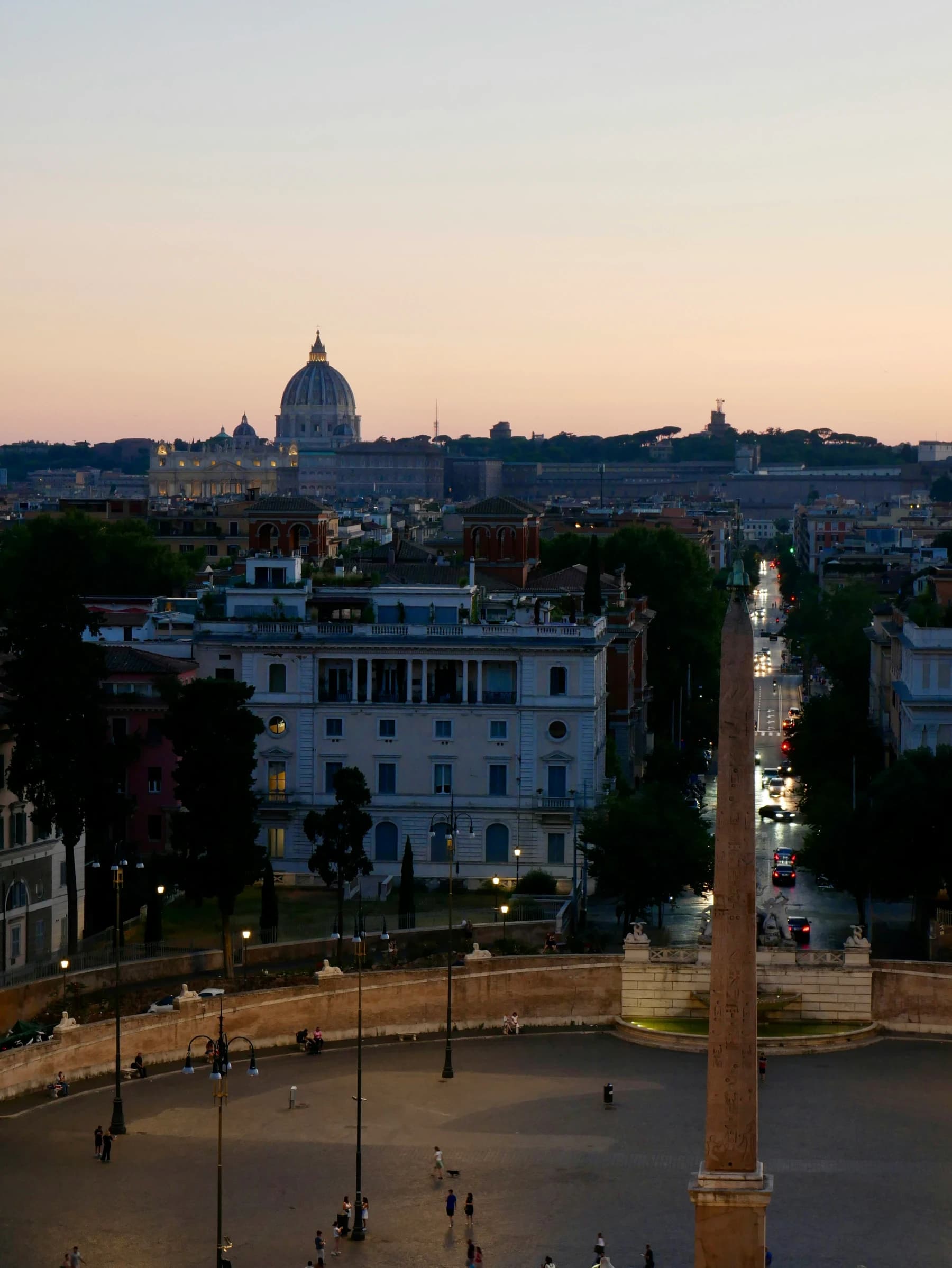 Pink dusk sky over Piazza del Popolo and St Peter's dome in summer