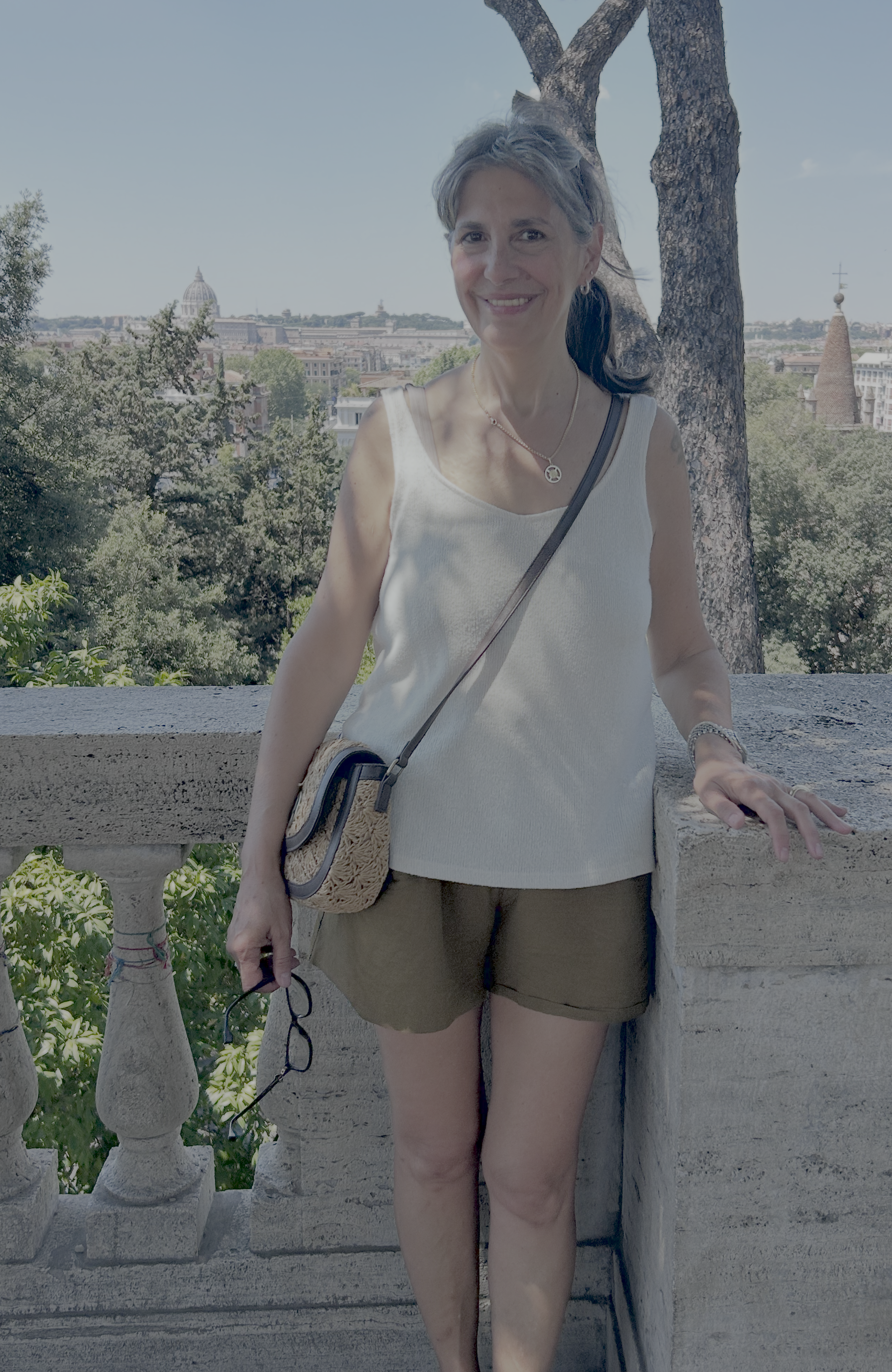 Jojo on a terrace above Rome, with the dome of St. Peter's behind her